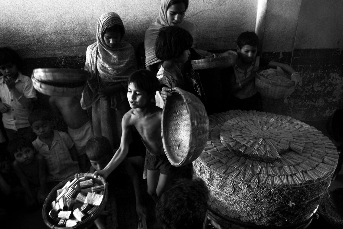 Child labors submit prepared bidi (leaf-rolled cigar made by tobacco prepared for smoking) to a factory contractor inside a factory at Sulitala village, Murshidabad 350 km north from the eastern Indian city of Kolkata, February 08, 2010.